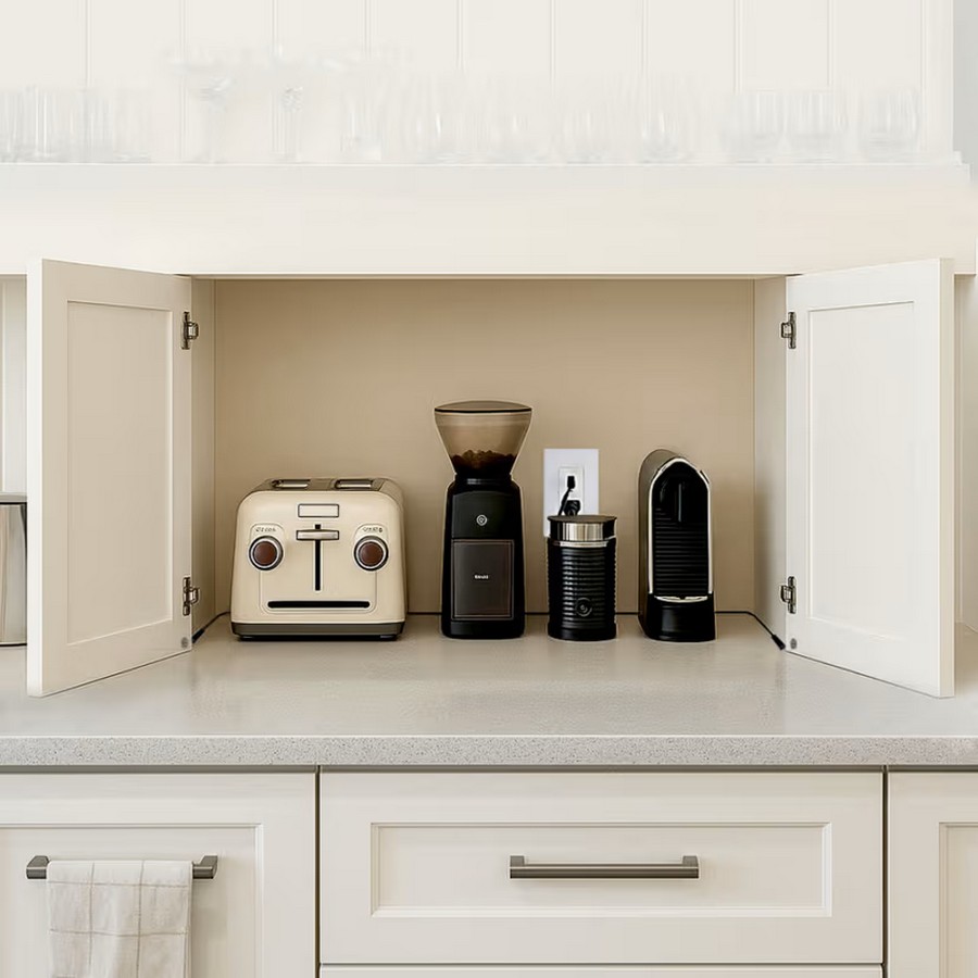 Countertop coffee station with a beige retro toaster a coffee grinder and a capsule espresso machine inside open white cabinets